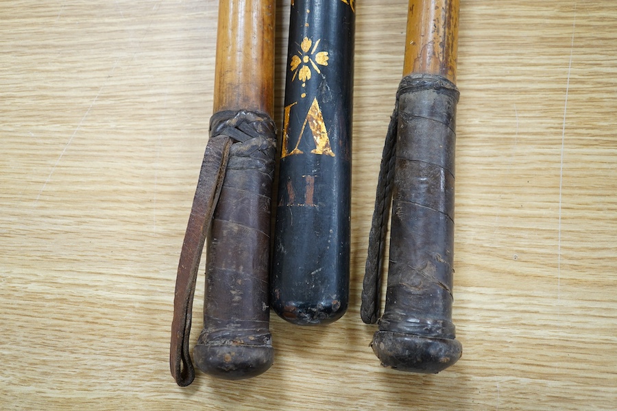 A William IV Victorian overpainted Special Constable truncheon and two bamboo shaft riding crops, largest 46cm. Condition - fair